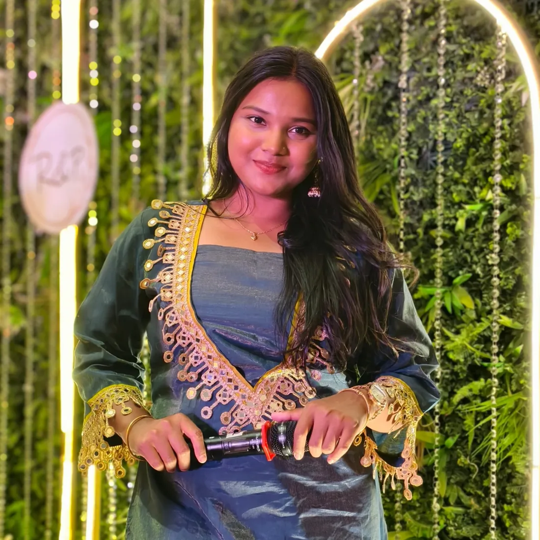 Smiling with the mic at a sangeet